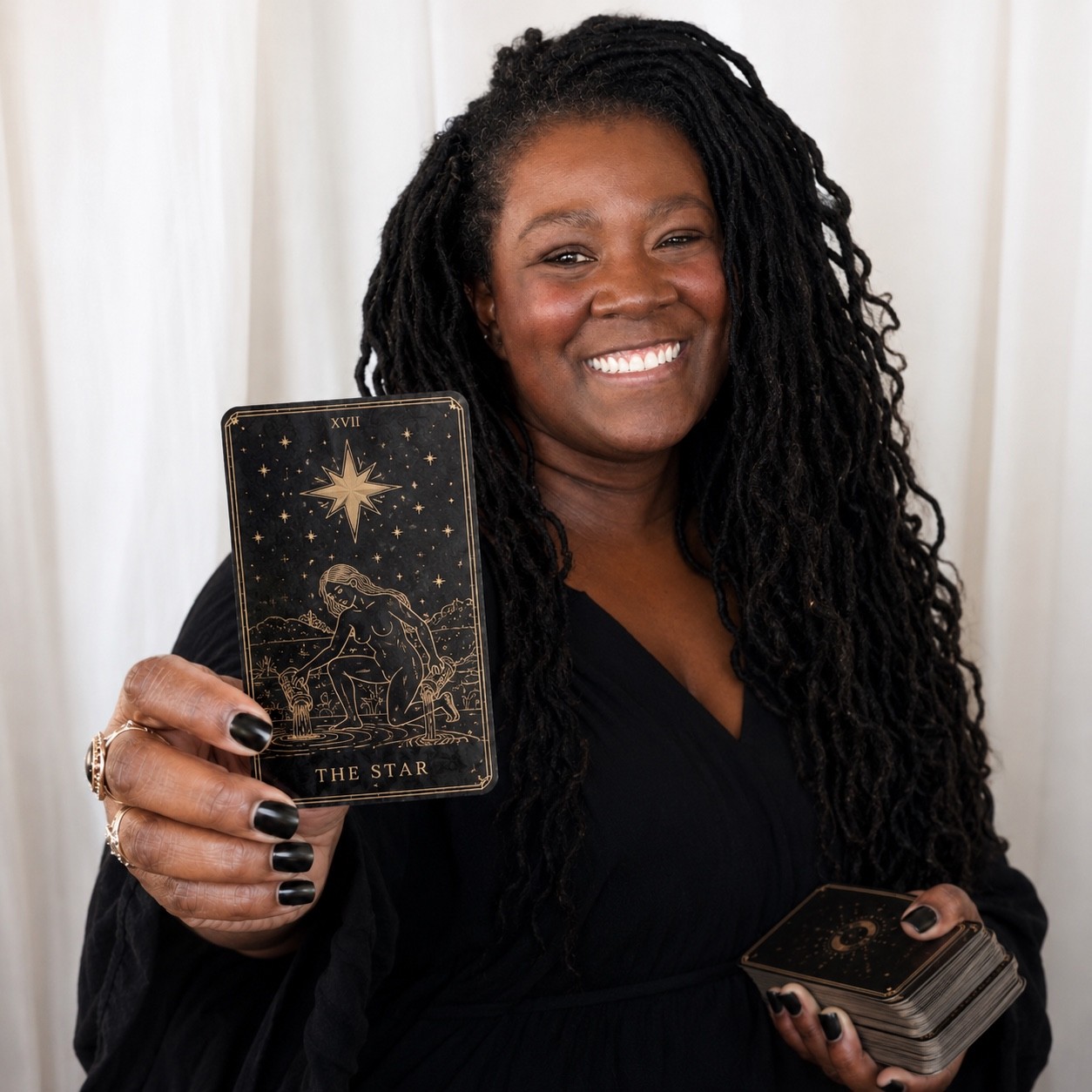 Reader behind The Midnight Draw holding The Star tarot card