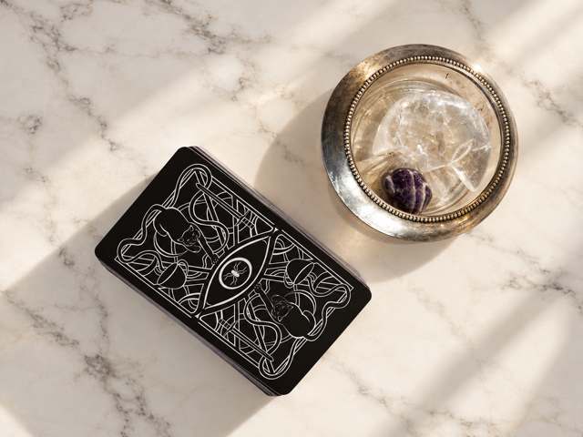 The Midnight Draw real event tarot reading table with styled cards and lighting